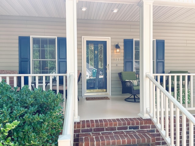 view of exterior entry featuring a porch