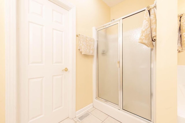 full bathroom with tile patterned floors, a shower stall, and baseboards