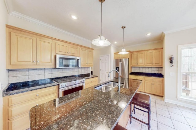 kitchen featuring a kitchen island with sink, light brown cabinets, a sink, premium appliances, and light tile patterned floors