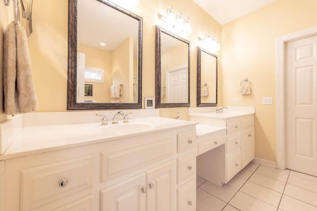 bathroom with tile patterned flooring, vanity, and baseboards