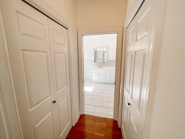 corridor featuring dark wood-style flooring