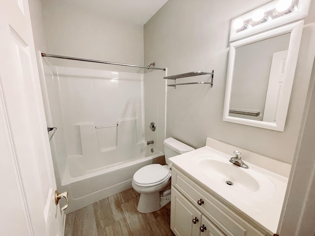 full bathroom featuring toilet, shower / washtub combination, wood finished floors, and vanity