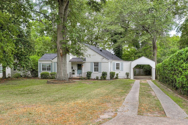 view of front of house with a carport and a front lawn