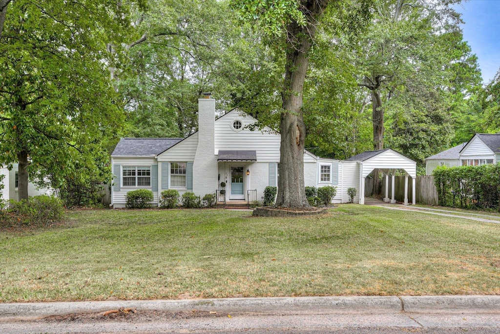 view of front facade with a front lawn and a carport