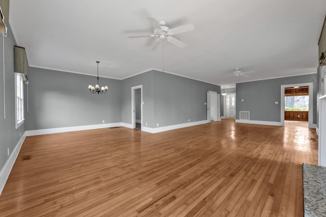207 W Liberty St, Washington, GA 30673 - unfurnished living room featuring baseboards, visible vents, ornamental molding, light wood-style floors, and ceiling fan with notable chandelier