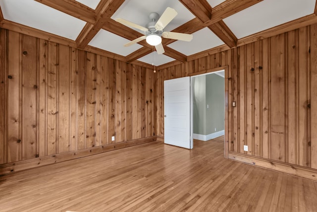 207 W Liberty St, Washington, GA 30673 - empty room with light wood finished floors, coffered ceiling, beam ceiling, and a ceiling fan