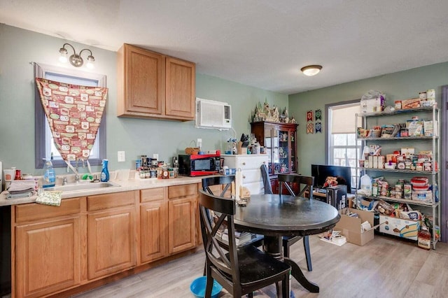 7419 Fullbright Rd, Appling, GA 30802 - kitchen with light wood-type flooring, light countertops, black microwave, and an AC wall unit