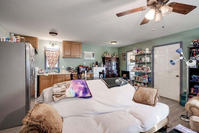 7419 Fullbright Rd, Appling, GA 30802 - bedroom featuring freestanding refrigerator, a ceiling fan, and light wood-style floors