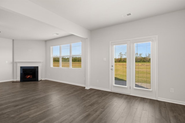 1254 Birch Cir, Grovetown, GA 30813 - unfurnished living room featuring dark wood-type flooring, plenty of natural light, and a lit fireplace