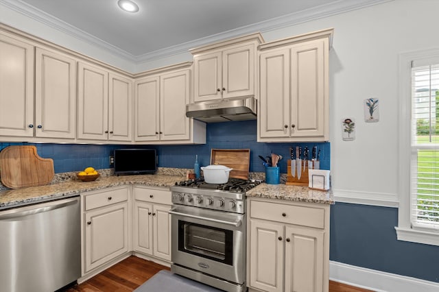 707 Hickman Rd, Augusta, GA 30904 - kitchen with stainless steel appliances, under cabinet range hood, cream cabinetry, backsplash, and dark wood finished floors