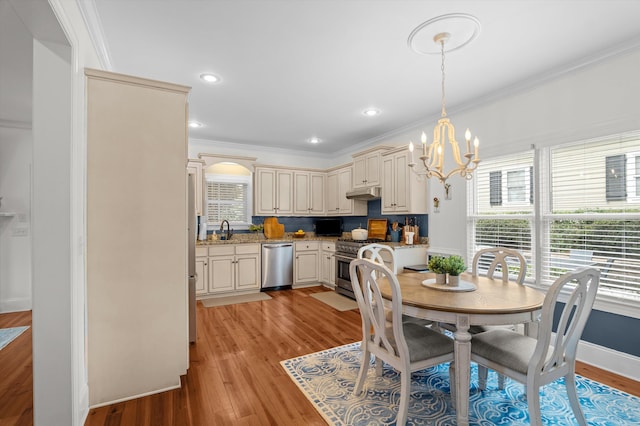 707 Hickman Rd, Augusta, GA 30904 - dining room featuring a chandelier, healthy amount of natural light, light wood-style floors, and ornamental molding