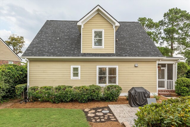 707 Hickman Rd, Augusta, GA 30904 - rear view of property with roof with shingles, a patio area, a sunroom, and a yard