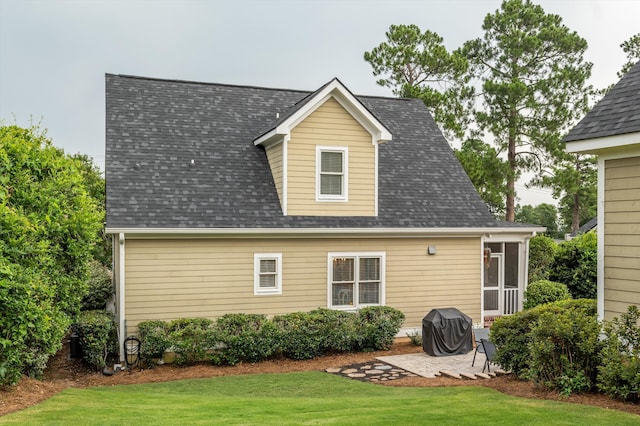 707 Hickman Rd, Augusta, GA 30904 - back of property with a lawn, a patio, and a shingled roof