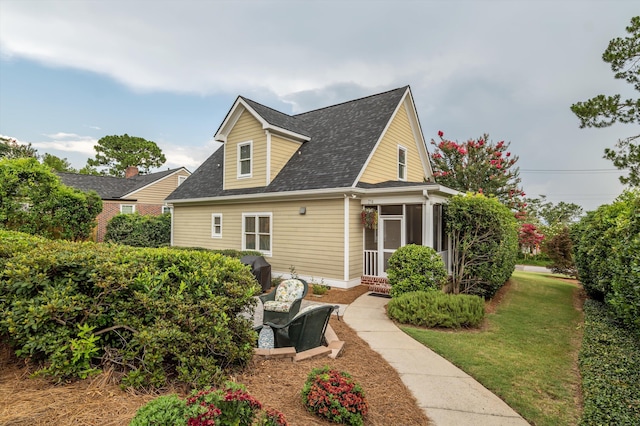 707 Hickman Rd, Augusta, GA 30904 - back of property featuring a sunroom, roof with shingles, and a lawn