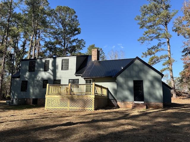 rear view of house featuring a deck