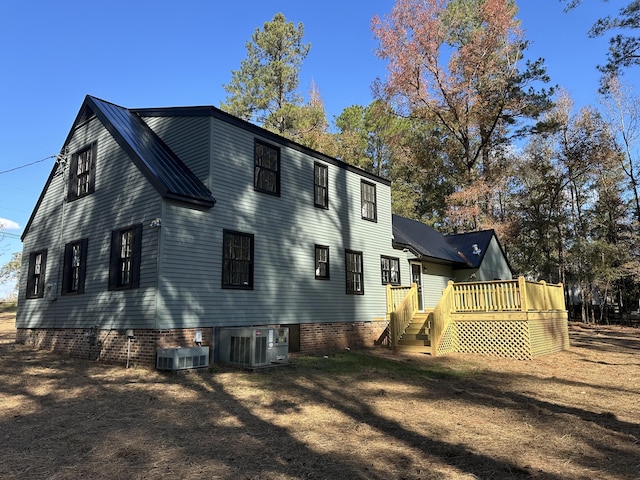 back of house featuring a deck and cooling unit