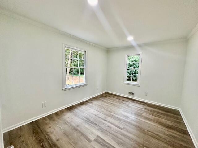 spare room with dark hardwood / wood-style flooring and ornamental molding