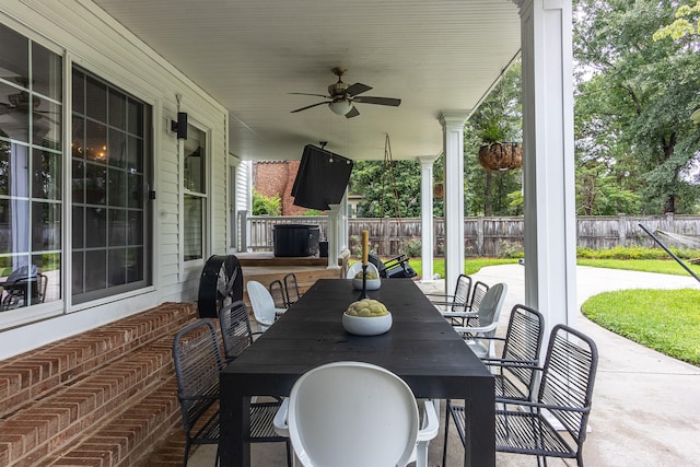 view of patio / terrace with outdoor dining area, ceiling fan, and fence
