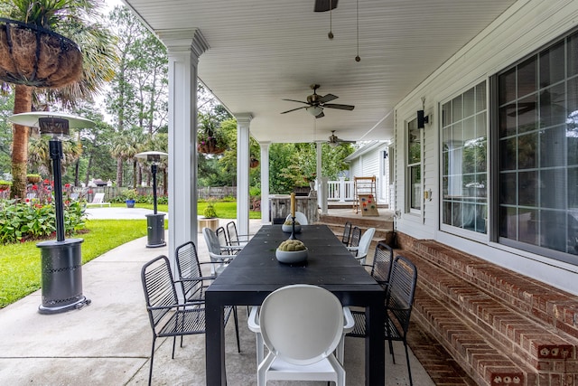 view of patio featuring a porch, outdoor dining space, and ceiling fan