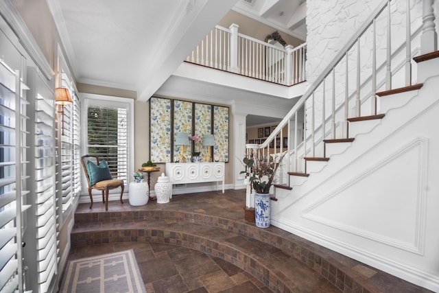 staircase with crown molding and stone finish floor