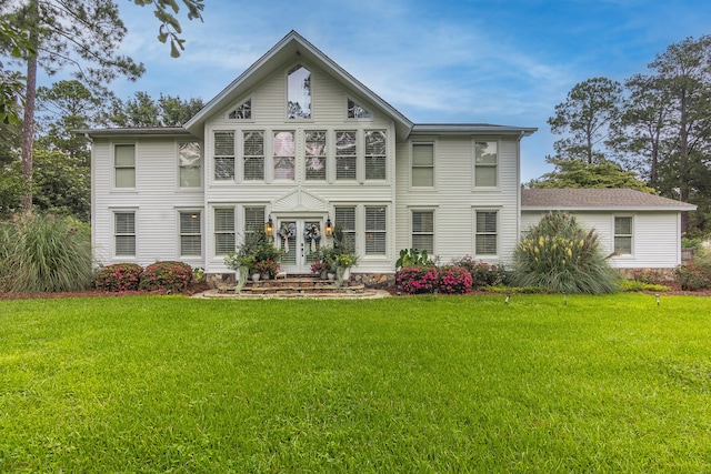 back of property featuring a lawn