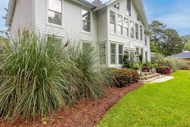 view of home's exterior featuring a yard