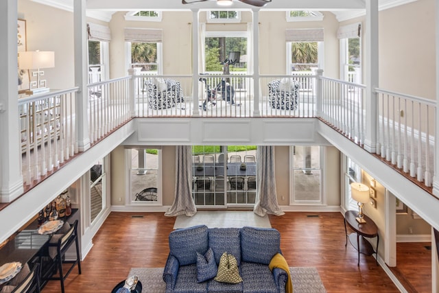 living room featuring a ceiling fan, wood finished floors, and baseboards