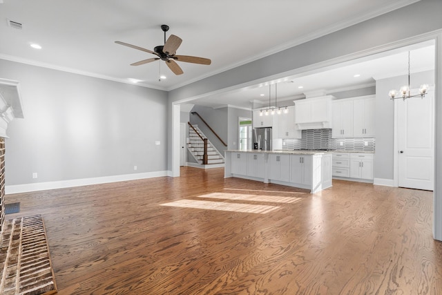 3067 Rosewood Dr, Evans, GA 30809 - unfurnished living room with ceiling fan, a brick fireplace, light wood-style floors, recessed lighting, and ornamental molding