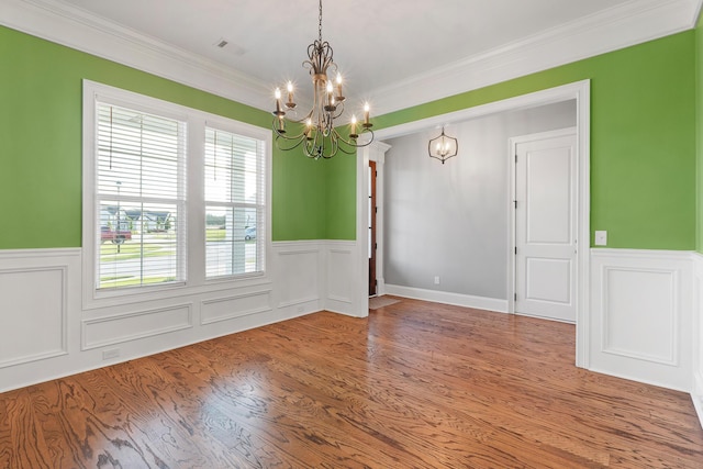 3067 Rosewood Dr, Evans, GA 30809 - spare room with a chandelier, a wainscoted wall, wood finished floors, and crown molding