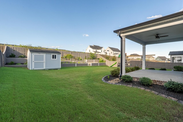 3067 Rosewood Dr, Evans, GA 30809 - fenced backyard with a shed, a vegetable garden, a patio, ceiling fan, and a residential view