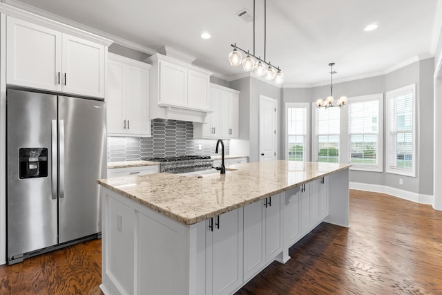 3067 Rosewood Dr, Evans, GA 30809 - kitchen featuring stainless steel fridge with ice dispenser, dark wood finished floors, white cabinets, a center island with sink, and backsplash