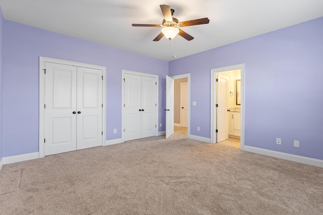 3067 Rosewood Dr, Evans, GA 30809 - unfurnished bedroom with multiple closets, light colored carpet, ensuite bath, and a ceiling fan