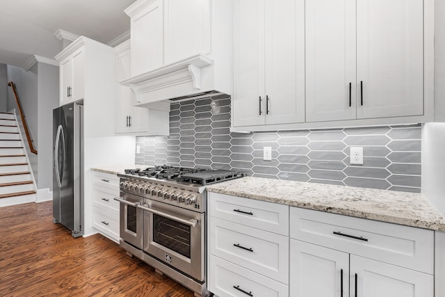 3067 Rosewood Dr, Evans, GA 30809 - kitchen with stainless steel appliances, white cabinets, tasteful backsplash, light stone counters, and crown molding