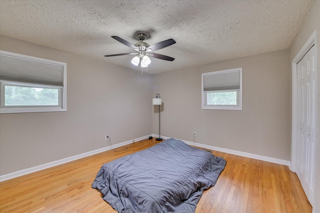 103 Adams Ln, Grovetown, GA 30813 - bedroom featuring wood finished floors, a closet, a textured ceiling, and ceiling fan