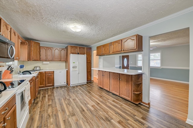 103 Adams Ln, Grovetown, GA 30813 - kitchen with white appliances, a textured ceiling, wood finished floors, brown cabinets, and crown molding