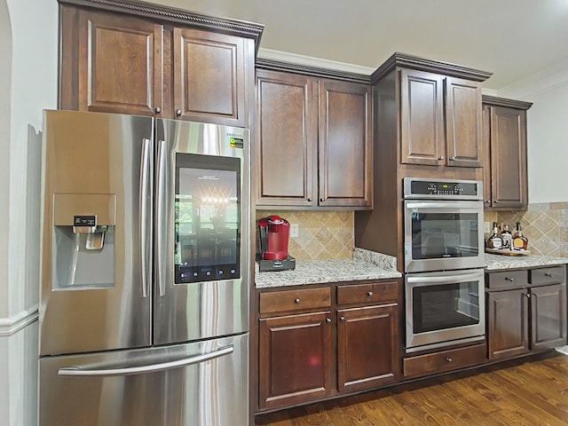 1038 Dietrich Ln, North Augusta, SC 29860 - kitchen featuring appliances with stainless steel finishes, decorative backsplash, dark wood-type flooring, light stone countertops, and dark brown cabinets