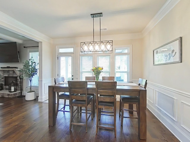 1038 Dietrich Ln, North Augusta, SC 29860 - dining space featuring a decorative wall, wainscoting, healthy amount of natural light, dark wood finished floors, and ornamental molding