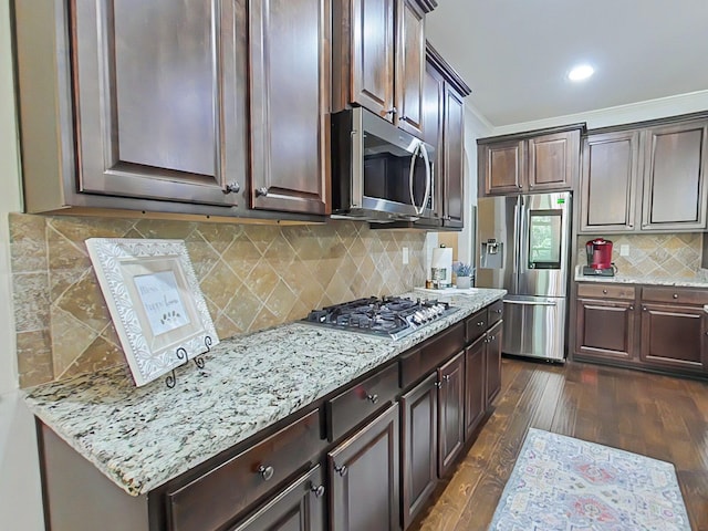 1038 Dietrich Ln, North Augusta, SC 29860 - kitchen featuring stainless steel appliances, dark brown cabinets, decorative backsplash, dark wood finished floors, and light stone countertops