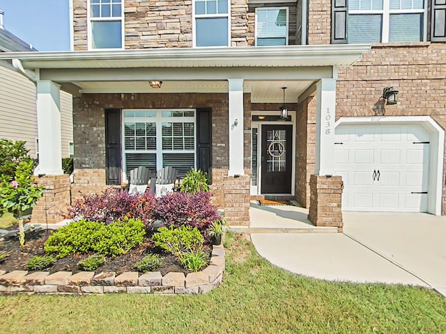 1038 Dietrich Ln, North Augusta, SC 29860 - property entrance featuring a porch, concrete driveway, an attached garage, and stone siding