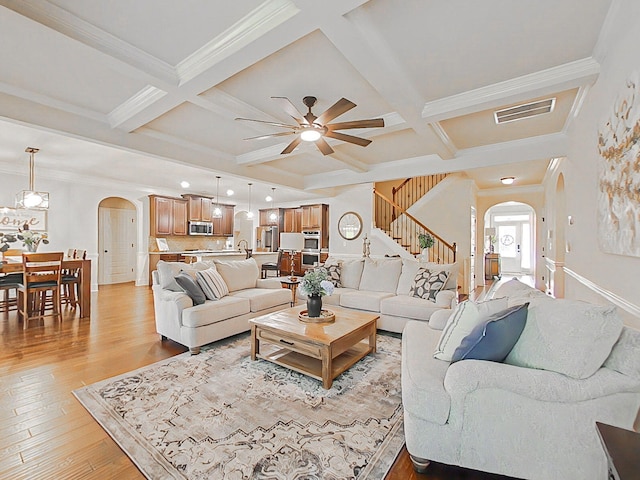 1038 Dietrich Ln, North Augusta, SC 29860 - living area featuring arched walkways, coffered ceiling, ceiling fan, light wood-type flooring, and beamed ceiling