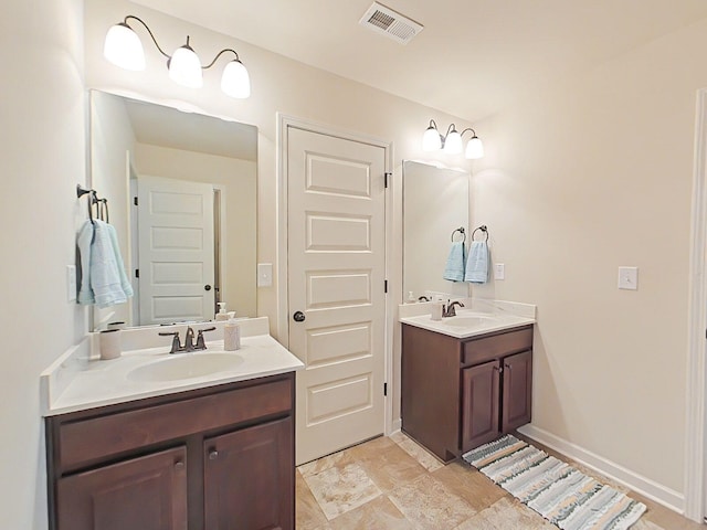 1038 Dietrich Ln, North Augusta, SC 29860 - full bathroom featuring two vanities and baseboards