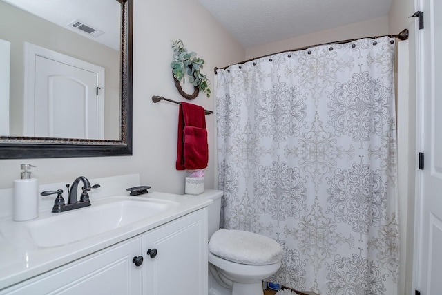 bathroom with toilet, vanity, and a shower with shower curtain