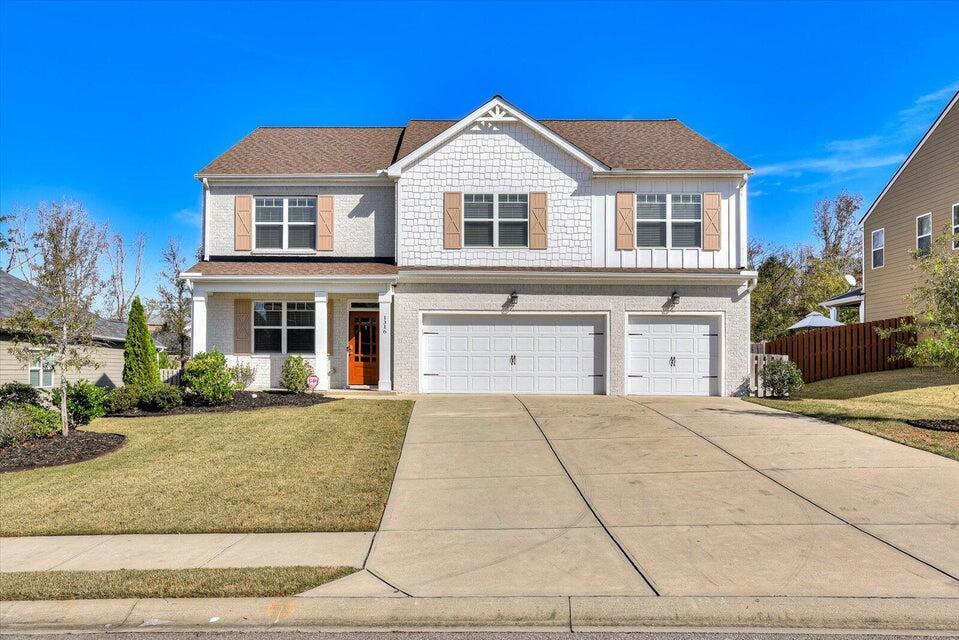 view of front of property with a garage and a front yard