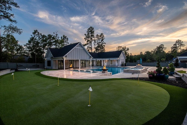 exterior space featuring a patio and a pool with hot tub