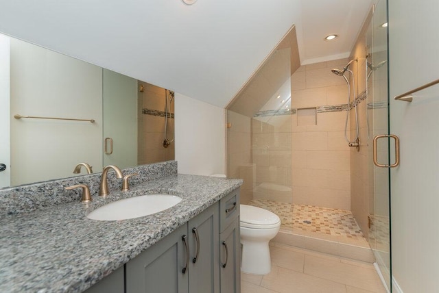 bathroom featuring tile patterned floors, vanity, toilet, and an enclosed shower