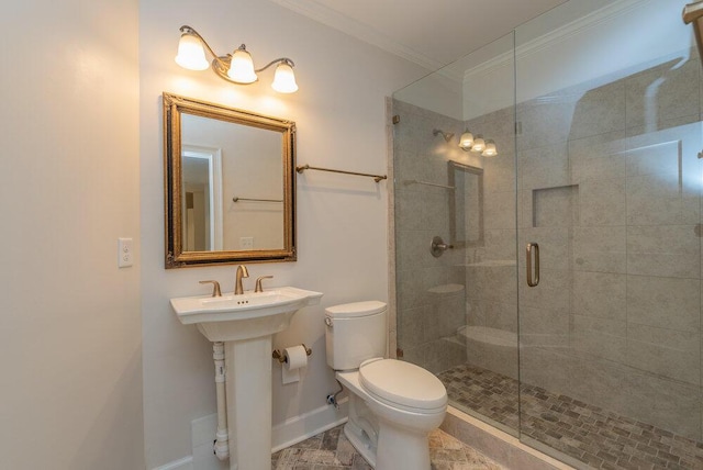 bathroom featuring sink, toilet, an enclosed shower, and crown molding