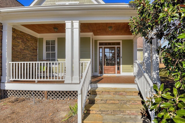 entrance to property with covered porch and brick siding