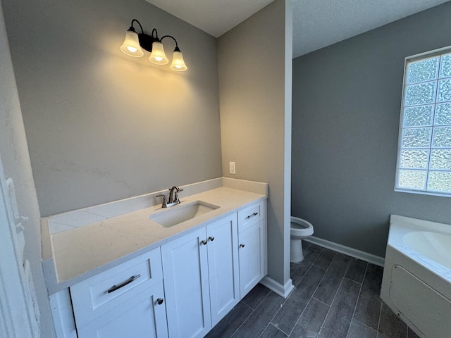 bathroom featuring vanity, toilet, and a bathtub