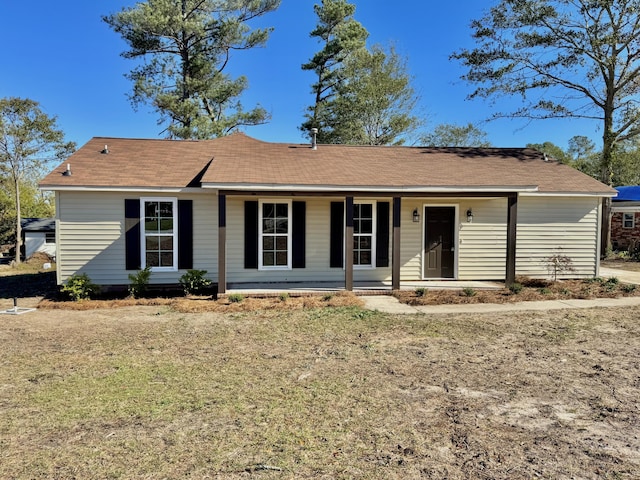 ranch-style house with covered porch and a front lawn