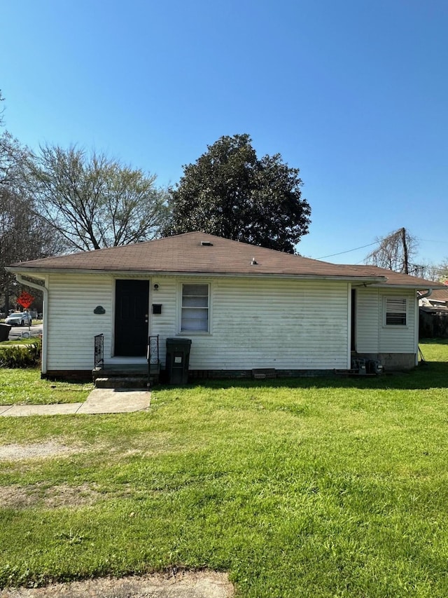 rear view of house with a lawn